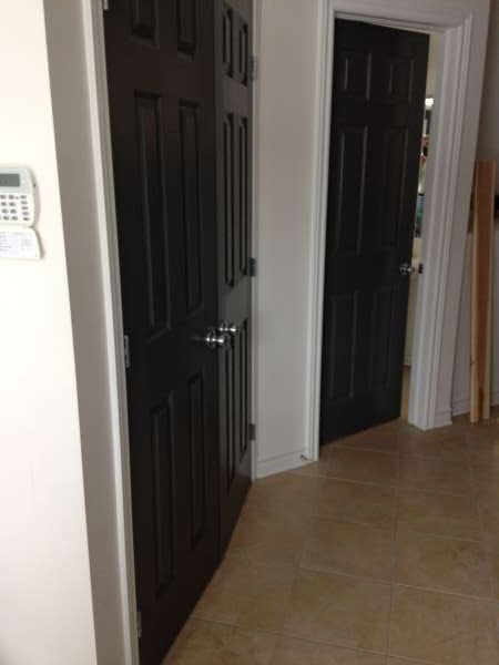 interior painting of black doors and entrance hallway of Orleans, Ontario home by painters PG PAINT & DESIGN
