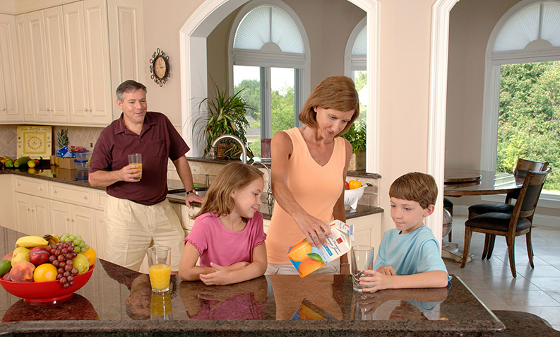 family in the kitchen of their painted house